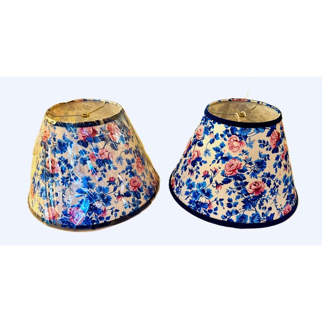 A beautifully made pair of new, unused floral fabric lampshades featuring a classic cottage‑style print in soft pinks and...