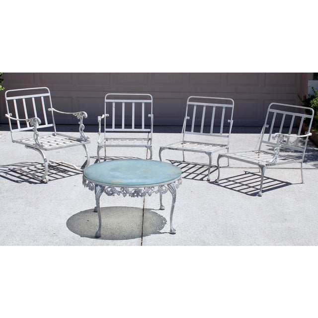 Elevate your outdoor space with this striking vintage 1950s cast aluminum patio set, a timeless example of mid-century...