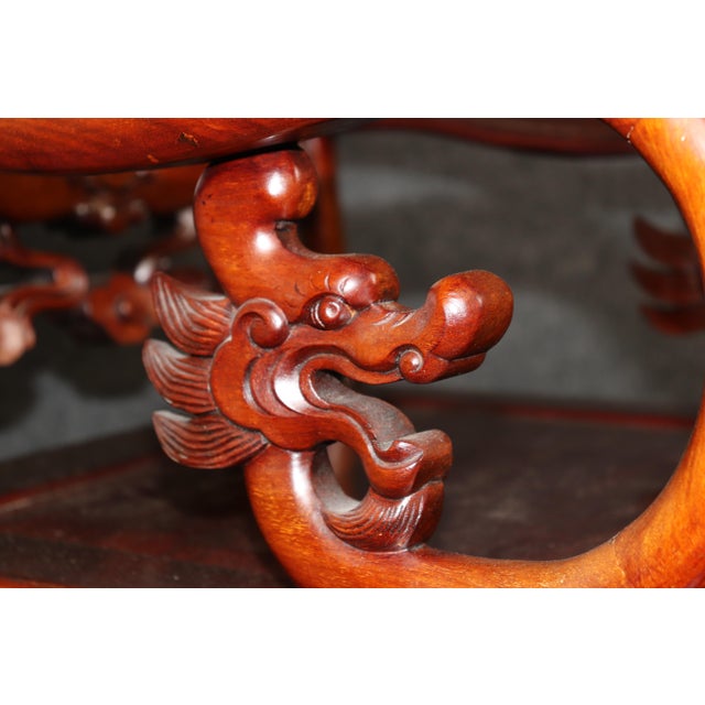 This extraordinary pair of Chinese hardwood armchairs is a magnificent expression of traditional Chinese craftsmanship,...