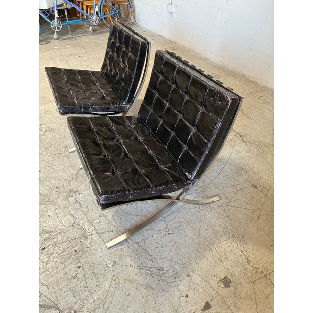 Incredible pair of classic Barcelona chairs by Mies Van Der Rohe for Knoll. This pair features perfectly patina'd black...