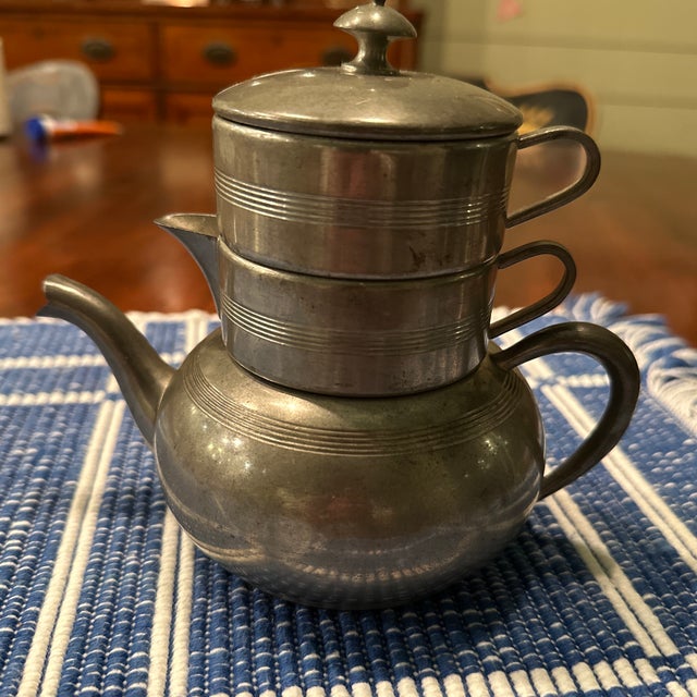 Pewter by Rice Child’s size stacking tea set. Tea pot with creamer and sugar pitcher plus top. One ding on the right side...