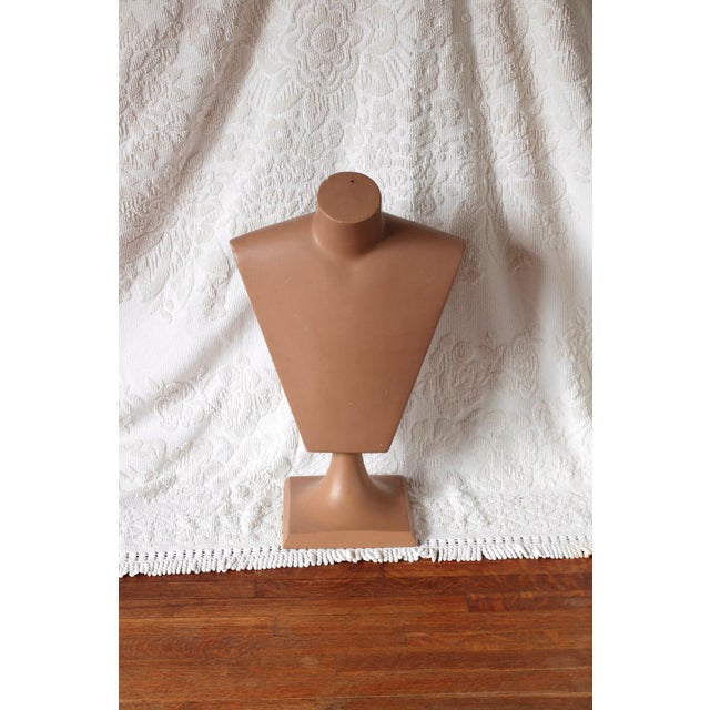 An Art Deco style male mannequin bust or in a pink or tan skin color. Possibly a vintage store display for shirts. Wood...