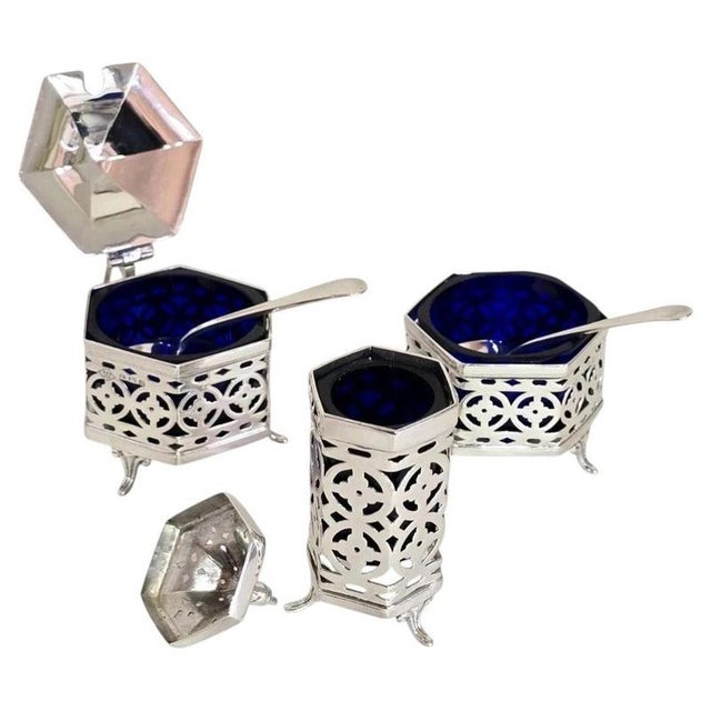 A fine antique sterling silver three-piece cruet set dating to 1926, displaying elegant traditional english silver...