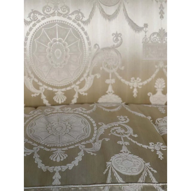 Late 19th century French Empire style sofa. Consists of beautiful hand-carved wood details all around and patterned gold-...