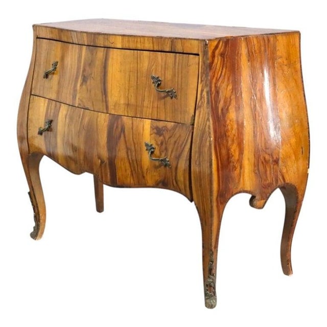 This Italian commode, crafted around 1900, exemplifies the elegant Rococo style with its distinctive bombe form....