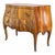 This Italian commode, crafted around 1900, exemplifies the elegant Rococo style with its distinctive bombe form....