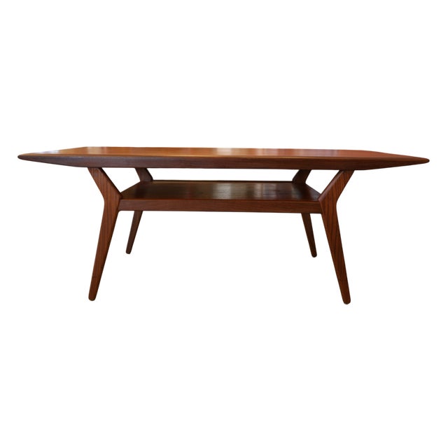 An elegant and well-proportioned Danish teak coffee table with a design language that catches the eye from all angles. The...