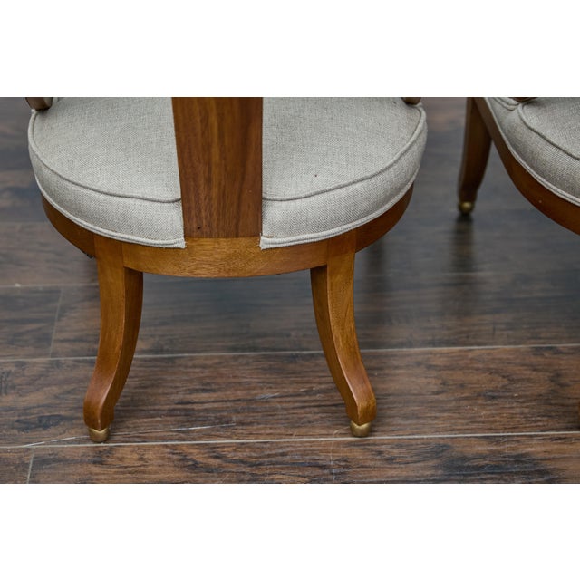 A pair of English style spoon back chairs from circa 1920 with low seats and curving legs resting on petite gilt spheres....