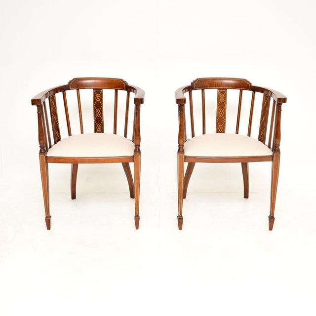 A stunning pair of antique Edwardian inlaid walnut armchairs. They were made in England, and they date from around the...