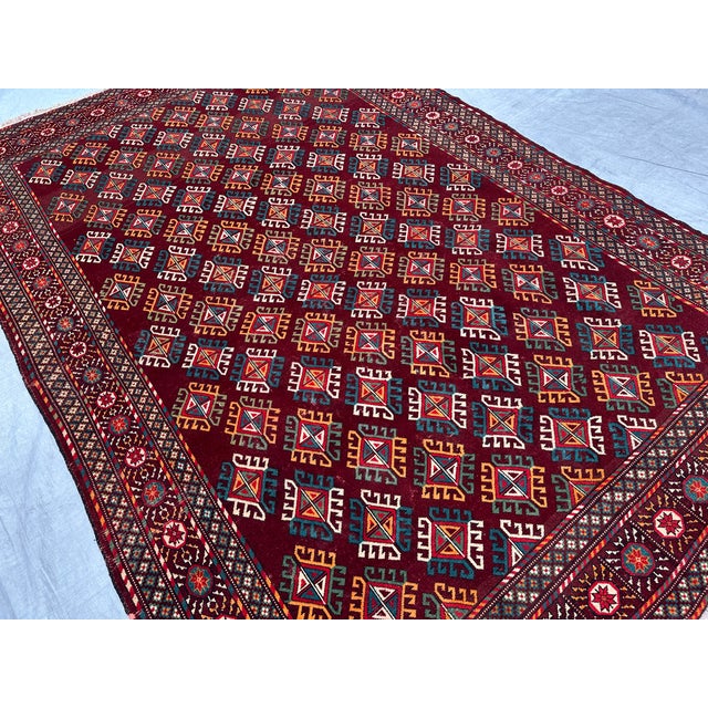 This antique hand-knotted Beshir rug features a dense diagonal lattice of stylized multicolor floral devices in gold,...