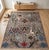 A hand-knotted area rug in the sickle-leaf design, woven in Afghanistan on a soft stone-grey ground with indigo, cream,...