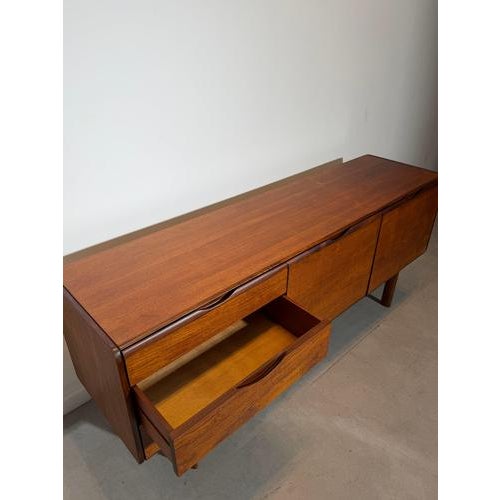 An elegant and highly functional teak sideboard by G-Plan, showcasing the clean lines and exceptional craftsmanship that...