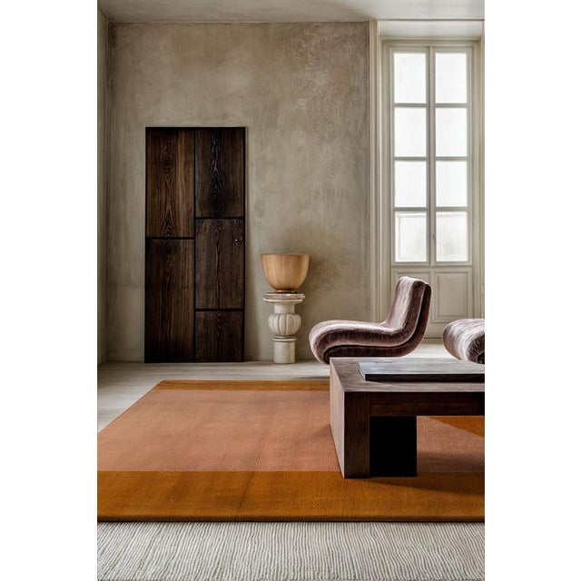 The Sandal Rug evokes the serene beauty of a warm sunset, where deep pink hues dance across the quiet desert landscape....