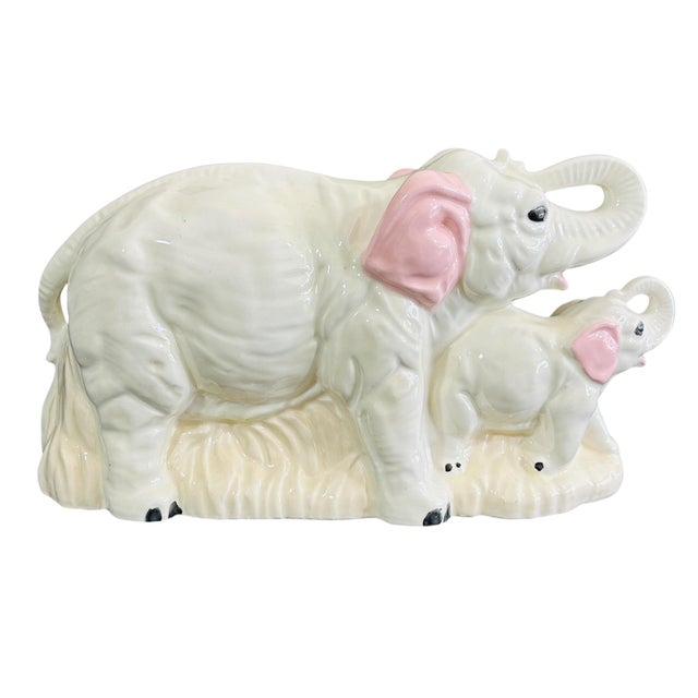 This charming vintage ceramic figurine from the 1970s captures a heartwarming moment between a mother elephant and her...