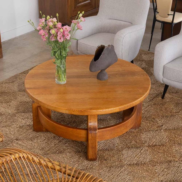 Stunning oak coffee table from France, 1950s. Solid oak circular table with arched stretchers connecting four block legs....