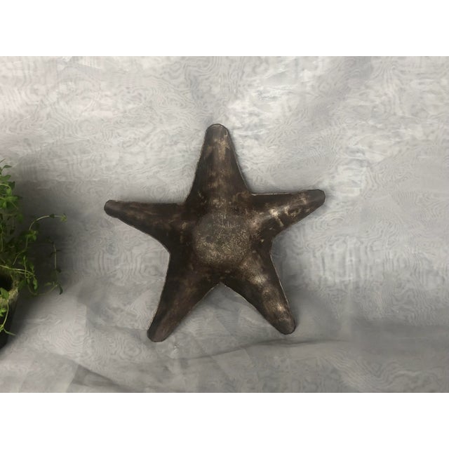 Display this decorative hand-wrought metal star catchall trinket tray as decor on a living room coffee table, entry hall...