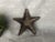 Display this decorative hand-wrought metal star catchall trinket tray as decor on a living room coffee table, entry hall...
