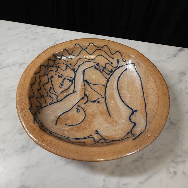Talk about functional art. This stunning hand-painted lounging female nude bowl is a conversation starter. Her color...