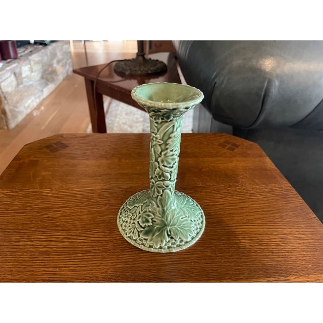 This handcrafted Bordallo Pinheiro candlestick holder features a rich green ivy pattern in a glossy majolica finish,...