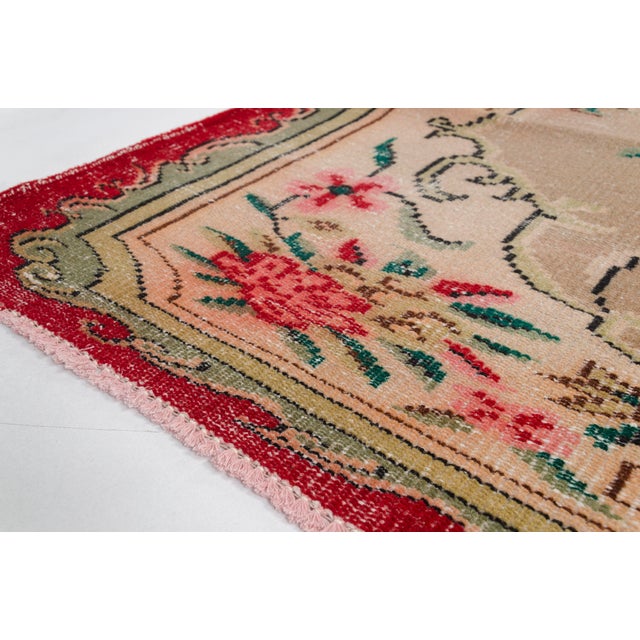This is a vintage Turkish Oushak rug from the 1960s. The piece was hand-knotted.