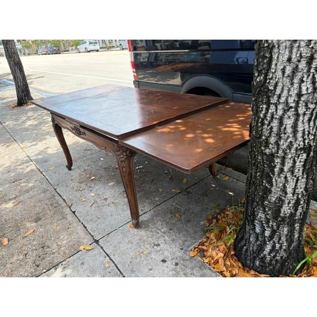 1900s oak drawer leaf table, some discolor to top , nice carved freeze. 106 inches fully extended.