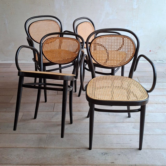This set of 4 Thonet no. 215 RF (coffee house) chairs was manufactured 1980 (as marked underneath the seat). The chair was...