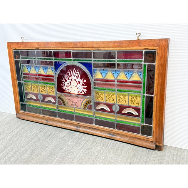 Design Plus Gallery presents a Stained Glass Window Panel from the 20th Century. The window panel is vibrant with stained...