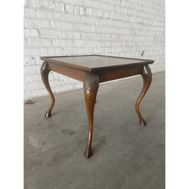 This mahogany cocktail table is the perfect size as a drink or occasional table. near square tray top on four curved legs...