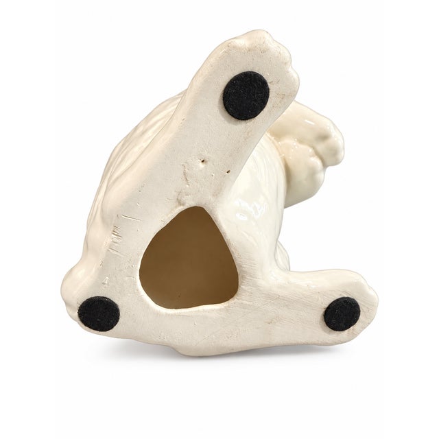 Charming vintage ceramic bunny figurine finished in glossy white with hand-painted black eyes and a sweet pink nose. The...