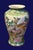 Vintage Chinese chinoiserie vase in green and gold. Hand-painted birds nestled among blooming florals and lush foliage....