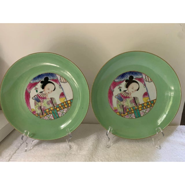 Pair of Chinese Famille Rose porcelain deep dishes/Bowes with green border and center depicting a beauty holding a fan in...