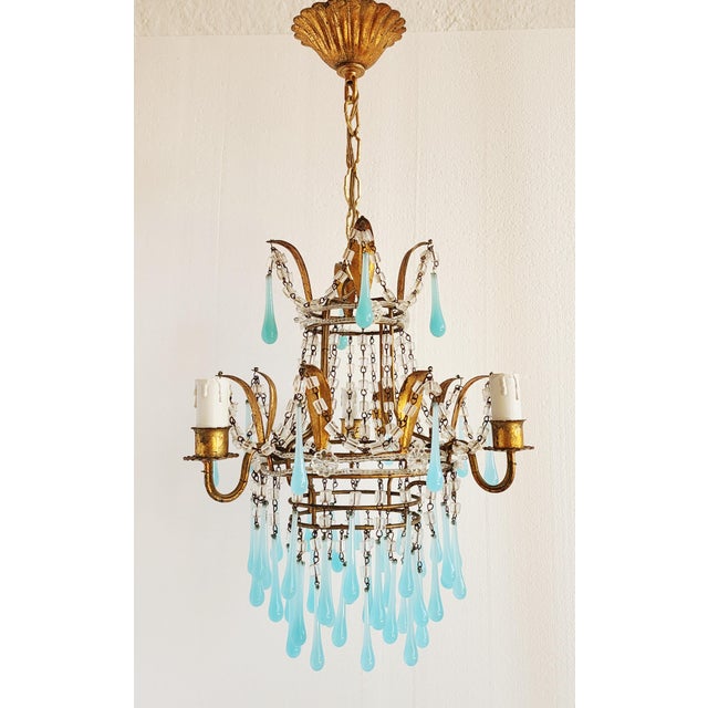 Vintage Mid-Century Italian gilt metal chandelier with light blue French opaline crystals. The small pendant chandelier...