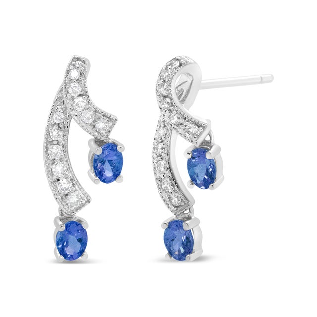 These unique earrings are sure to turn heads. Each earring features two ribbons of diamond accented 14K White Gold weaving...