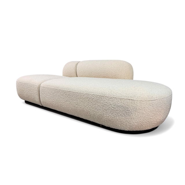 Eichholtz 2-Piece Cream Boucle Modern Minimalist Sofa. Features cream bouclé upholstery and a black finished plinth-style...