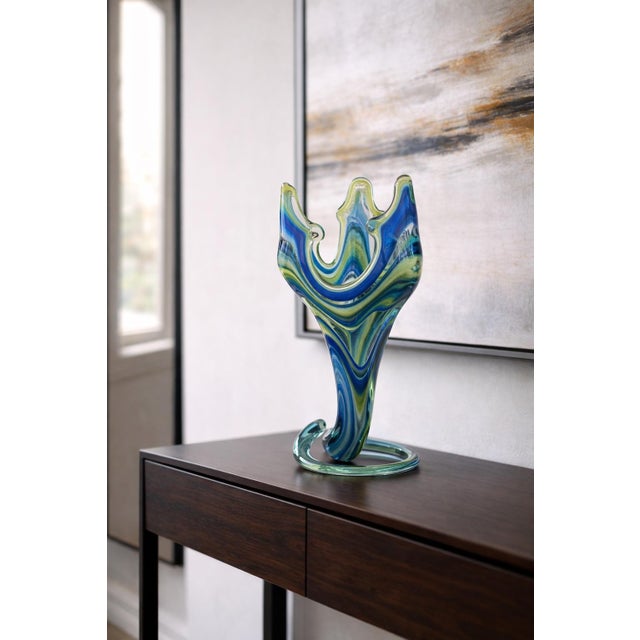 Contemporary hand-blown studio art glass sculpture in layered blue, teal, and chartreuse tones with dramatic freeform...
