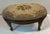Beautiful antique French needlepoint footstool with carved cabriole legs and nail head trim.