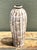 This vintage ceramic vase features a graceful, elongated silhouette finished in a striking brown and white crackle glaze....