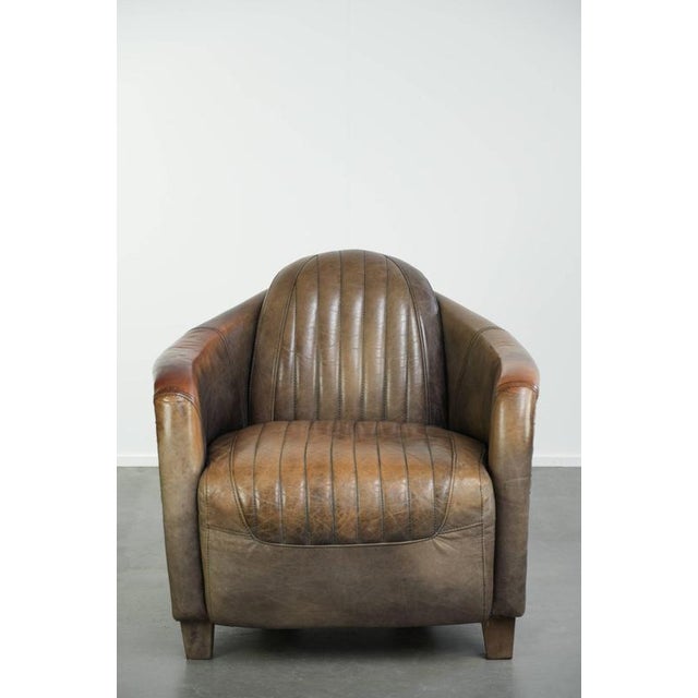 This rugged cowhide leather armchair in an aviator design is full of character and features a unique aluminum finish. The...