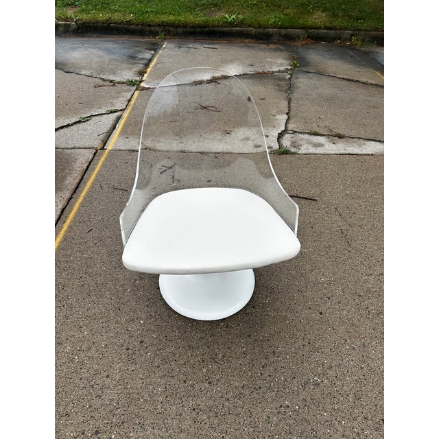 Stellar space age lucite swivel chair with white tufted upolstery. Attributed to Laverne’s champagne chair. Circa 1970’s...