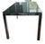 Original black glass dining table with chrome legs from the 1980s. Italian design in the style of Metal Arredo Paderno Di...