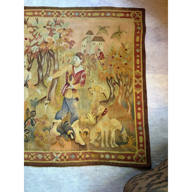 Incredible earth tone tapestry of a hunting scene. Features two men, dogs and foliage in an array of salmons, terracotta,...