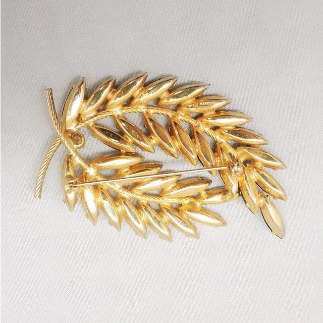 This is part of Chairish’s Costume Jewelry assortment. 1960s goldtone prong set marquise faux-onyx and white rhinestone...