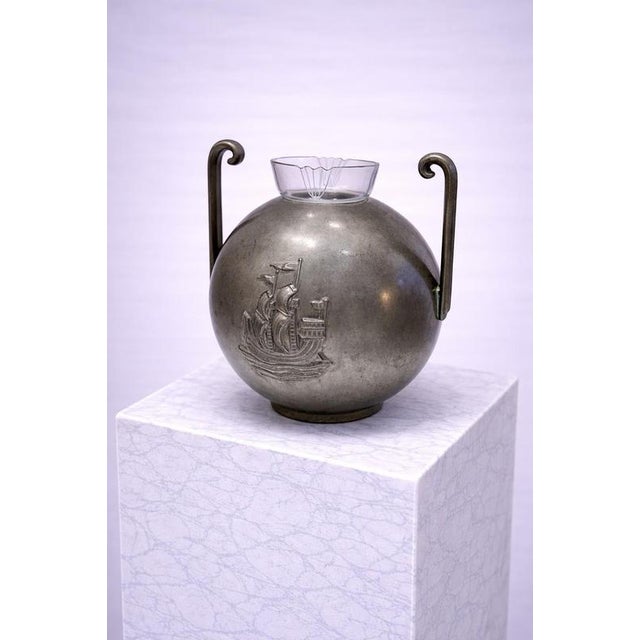 Swedish pewter vase designed by Sylvia Stave for CG Hallberg, dated 1934. The piece has a rounded, sculptural form with...