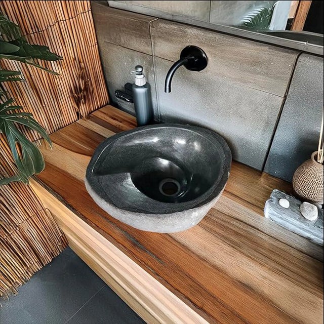 Add a sense of grounded luxury to your bathroom with our hand-carved river stone vessel sink. Unearthed from Indonesian...