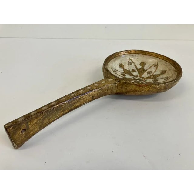 Charming vintage Florentine dipper crafted from wood with gilt and gesso decoration, featuring a starburst floral motif in...