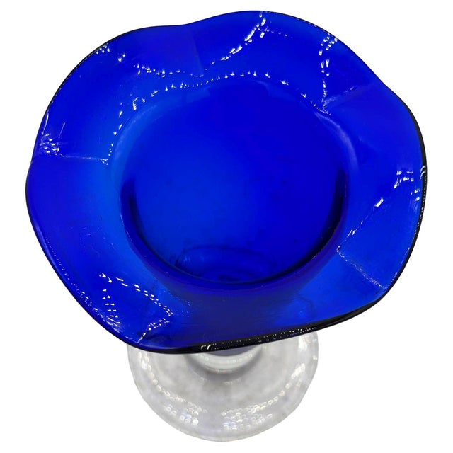 Original 9” Tall cobalt blue glass hand-blown vase with a ruffled rim by AAC Handcrafted. The vase features a beautifully...