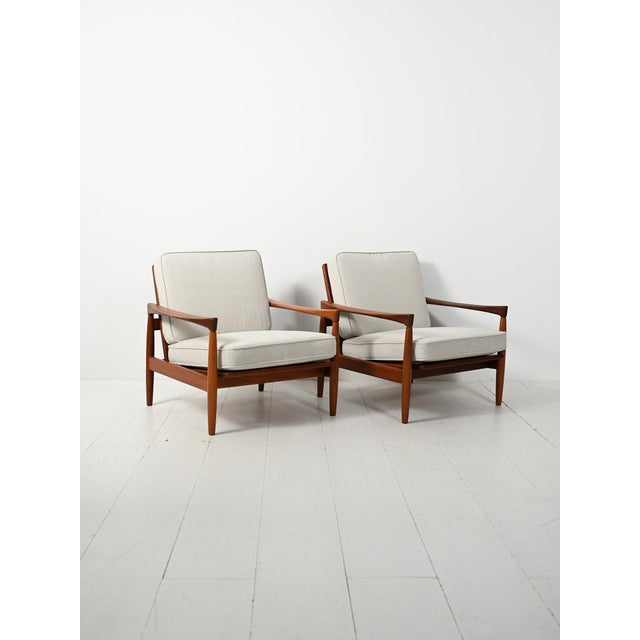 An elegant pair of Danish armchairs from the 1960s, the "Kölding" model by Erik Wørts. Teak frame and cushions upholstered...