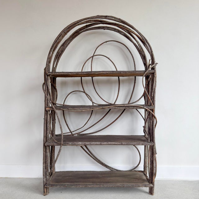 A charming and sculptural rustic twig shelf, crafted from natural bentwood branches in a decorative arched form. This...
