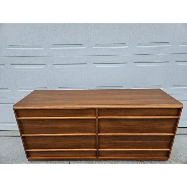 This classic walnut double chest of drawers or dresser is designed by T.H. Robsjohn-Gibbings for Widdicomb out of Grand...