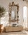 A large Italian wall mirror in Grotto style, crafted from painted hand-carved wood with richly carved relief decoration....
